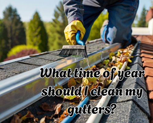 a worker cleaning roof gutters